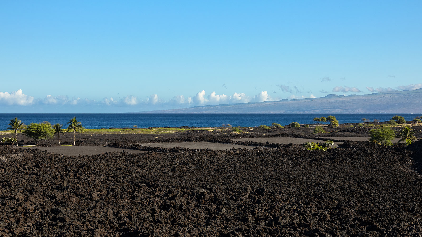 Volcanic flows at the edge of the ocean create a rugged shoreline