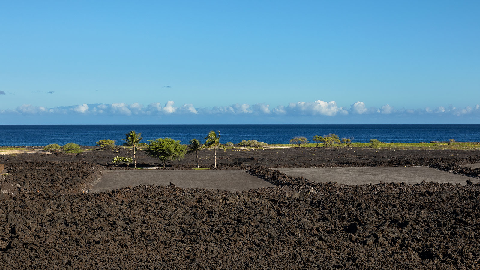 Volcanic flows at the edge of the ocean create a rugged shoreline