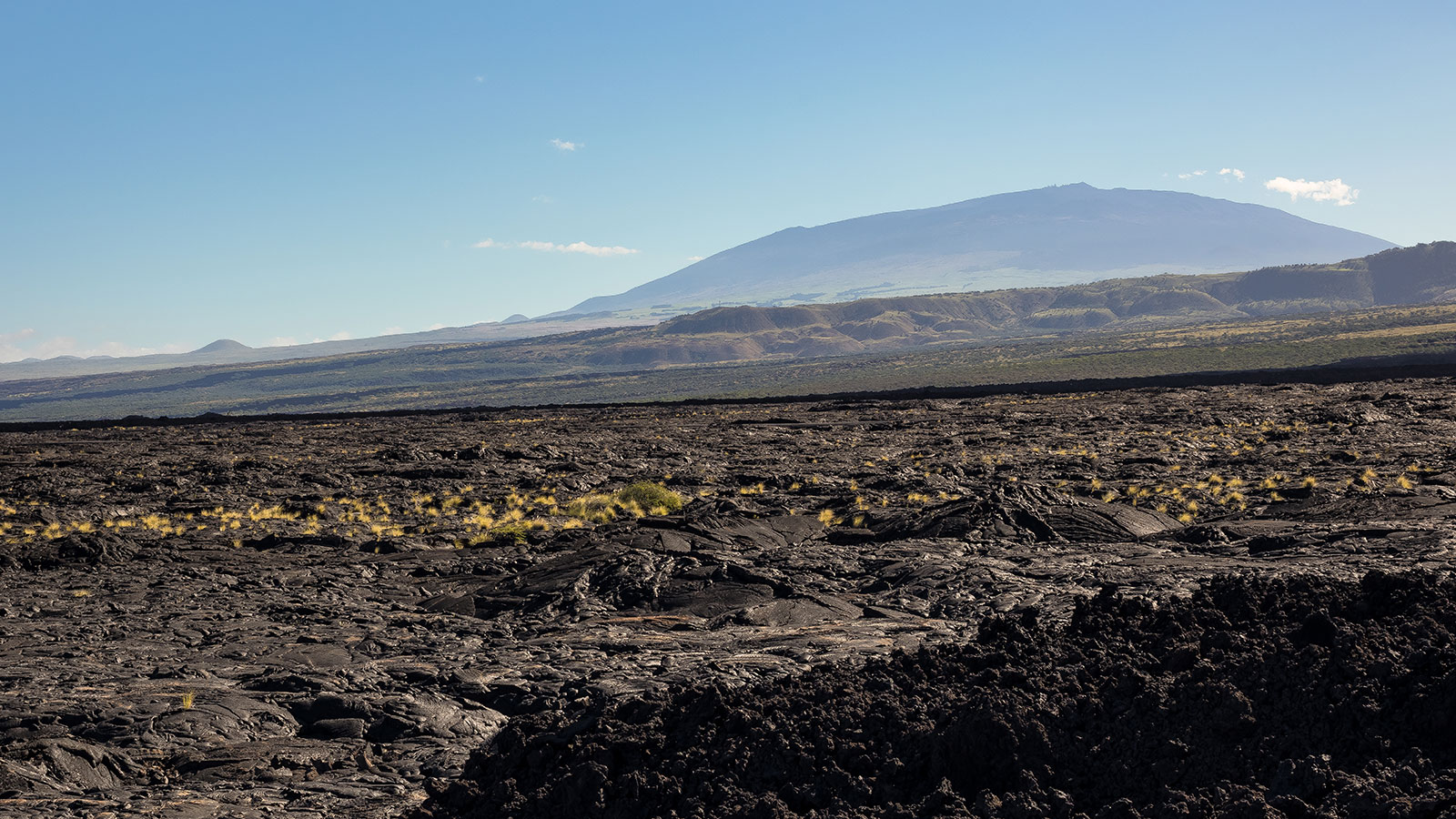 Dramatic geography features lava fields rolling out across big island Hawaii